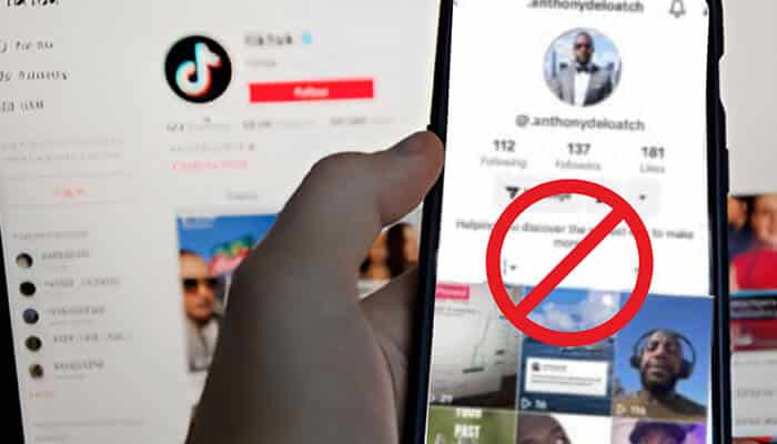 A person holding two smartphones displaying TikTok profiles, illustrating the process of How To Block Someone On TikTok, with one screen showing a red prohibition symbol indicating a blocked user