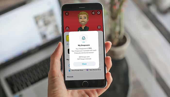 A person viewing their Snap Score on Snapchat, demonstrating how does Snap Score work on a smartphone screen with the user's score visible