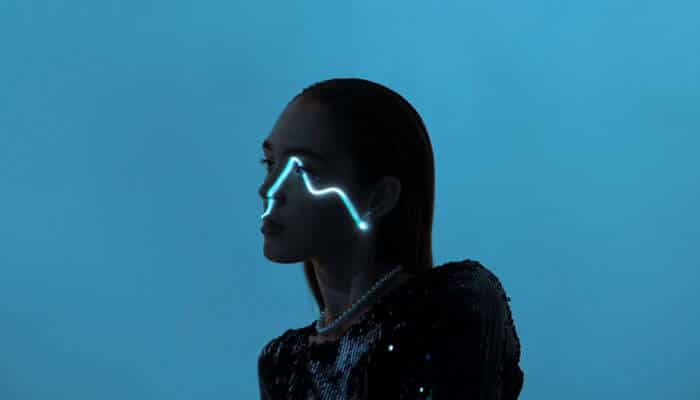 Person with glowing futuristic eye design, symbolizing the cutting-edge technology of free AI models in modern creative projects.