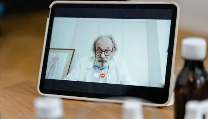Doctor providing a virtual consultation through video call, showcasing how telehealth supports patient care and innovation in aesthetic practice marketing.