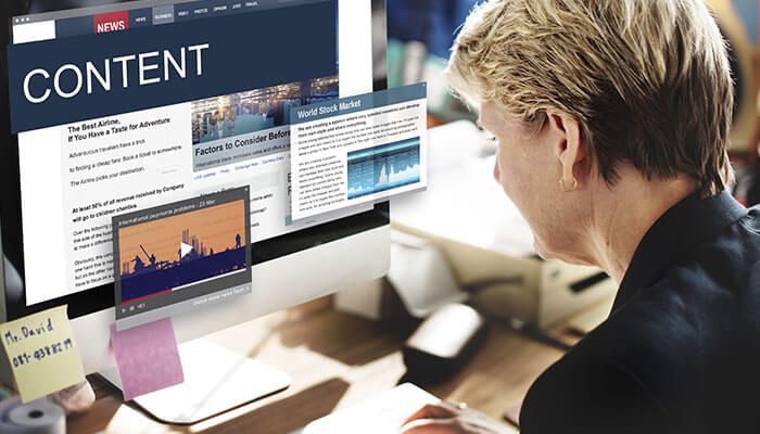 A student entrepreneur working on a computer, researching content related to business, stock markets, and industry trends, with multiple tabs open for analysis.