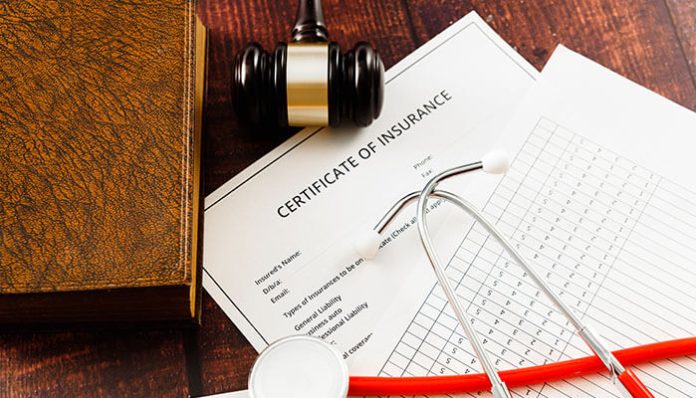 Certificate of Insurance documents with gavel and stethoscope, symbolizing compliance and risk management supported by automated tracking software.