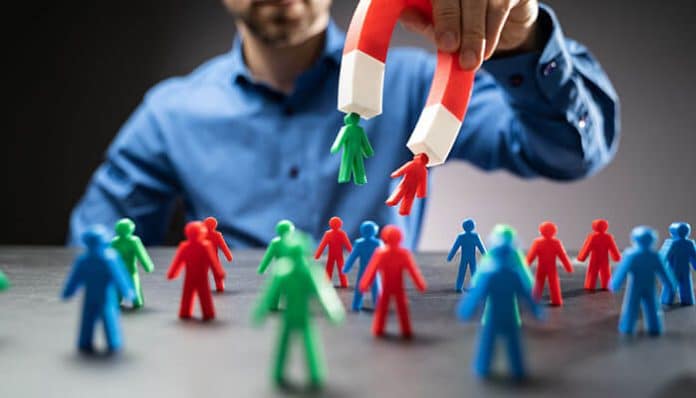 Illustration of a person using a magnet to attract figures, symbolizing the concept of attracting leads and avoiding mistakes in property promotion