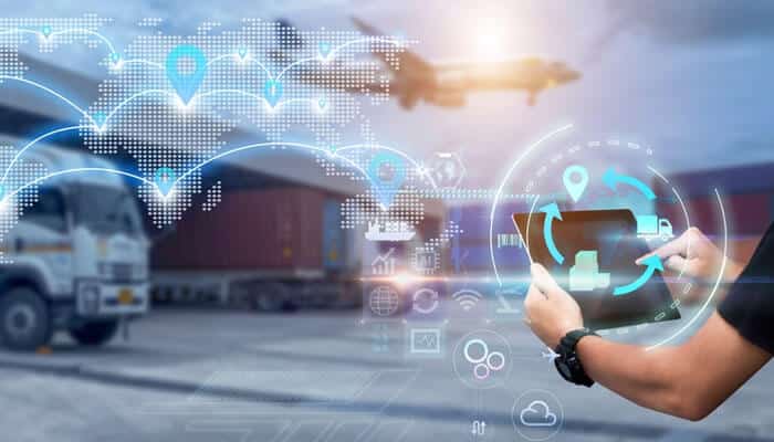 The future of logistics in Indiana is showcased through a person interacting with a digital tablet, surrounded by icons and global connectivity symbols, while trucks and an airplane are visible in the background