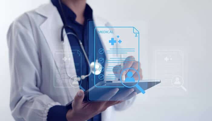 Doctor reviewing digital medical documents on a tablet for preparing a Medico Legal Report.